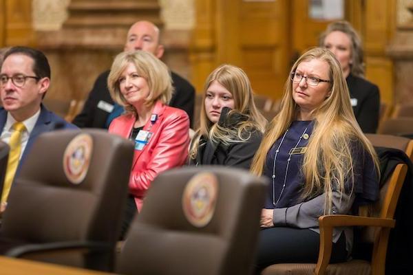 People sitting in the chamber of commerce audience.